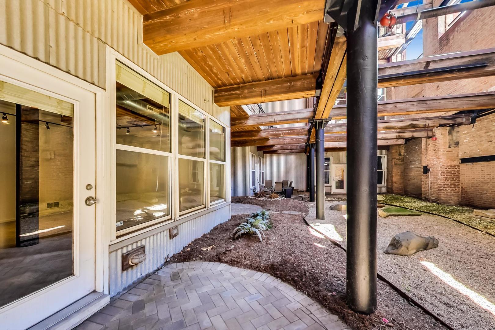 1000 West Washington Boulevard, Unit 130 Chicago, IL 60607 - Photo 39 of 47 a view of a porch with a table and chairs