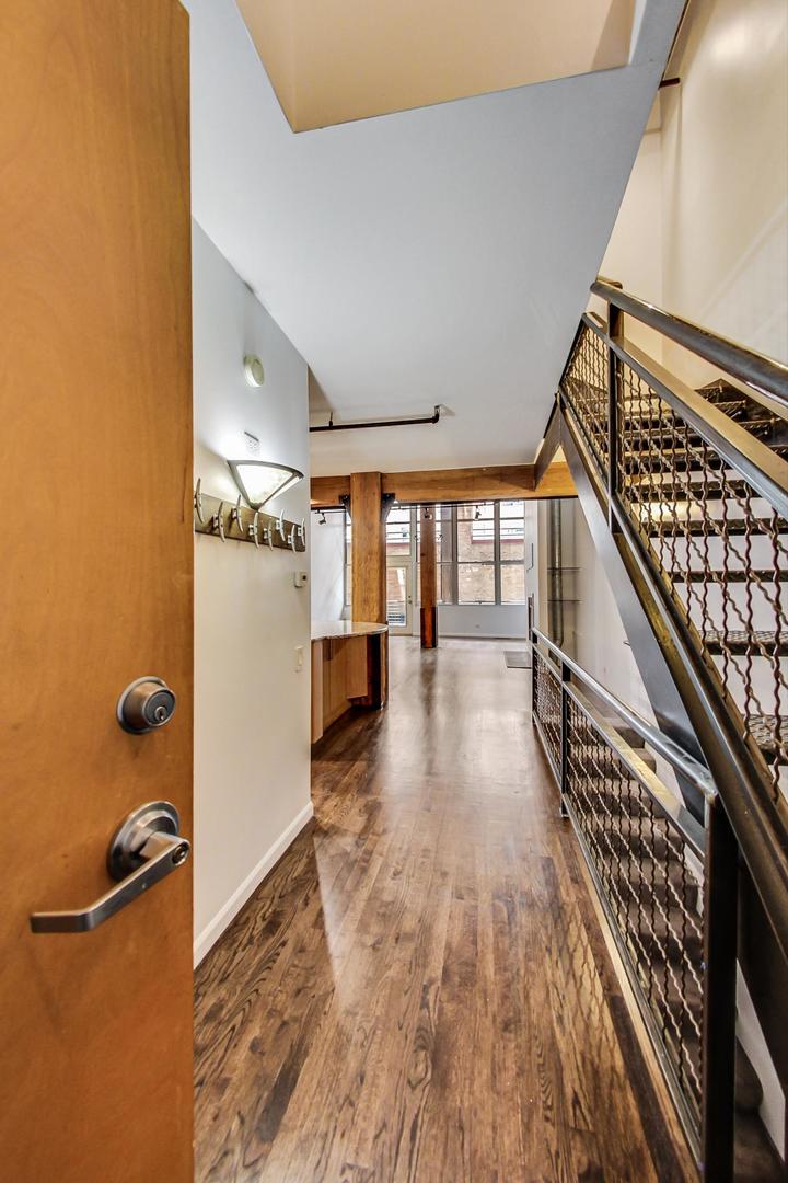 1000 West Washington Boulevard, Unit 130 Chicago, IL 60607 - Photo 9 of 47 a view of entryway and hall with wooden floor
