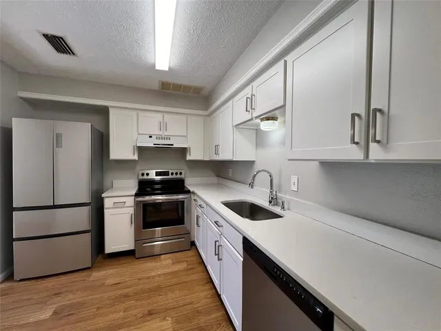 a kitchen with a sink and cabinets