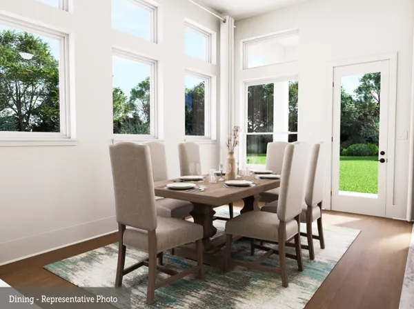 a view of a dining room with furniture window and wooden floor