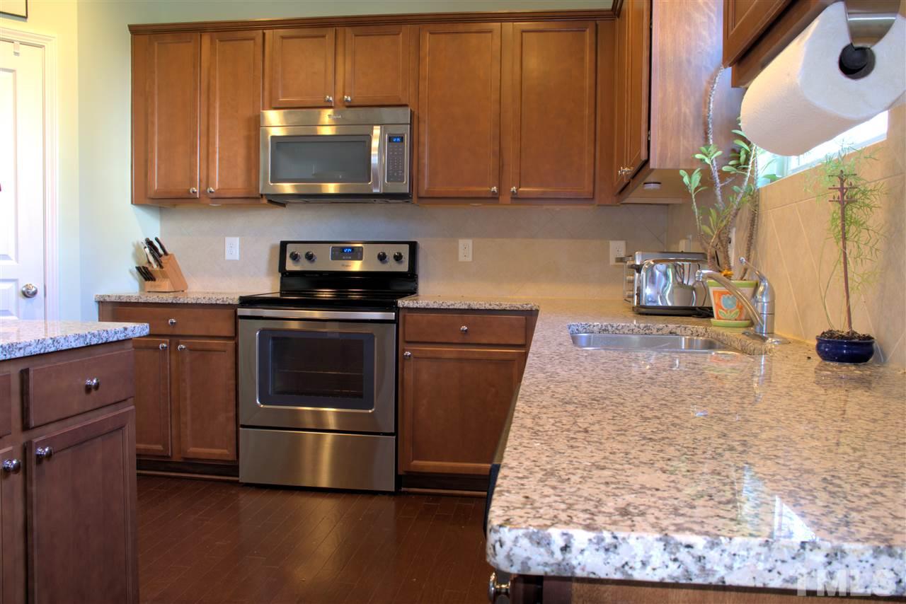8137 Hovingham Way Raleigh, NC 27616 - Photo 2 of 20 Roomy kitchen with granite counter tops and plenty of cabinet space,