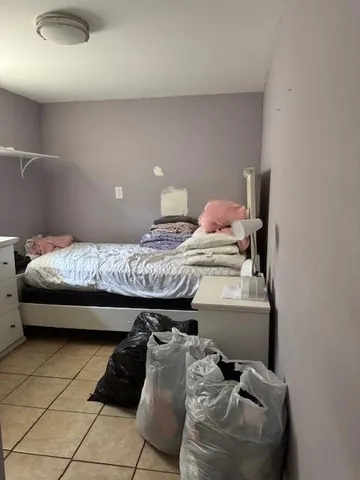 a bedroom with a bed and a lamp