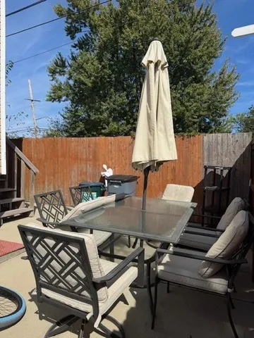 a view of a backyard with furniture and a tub