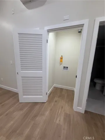 an empty room with wooden floor and closet