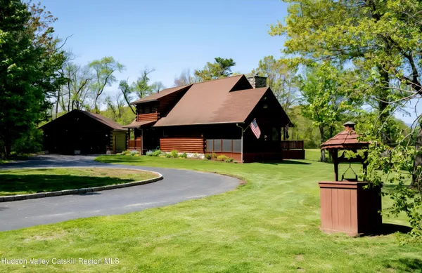 a front view of house with yard and outdoor seating