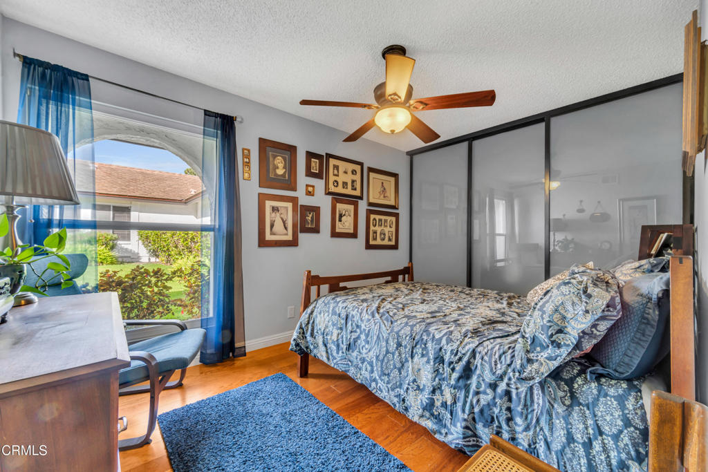 5290 Shiloh Way Ventura, CA 93003 - Photo 11 of 22 a bedroom with a bed and a chandelier