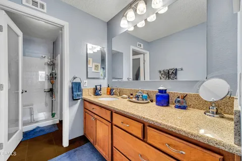 a bathroom with a sink double vanity and a mirror