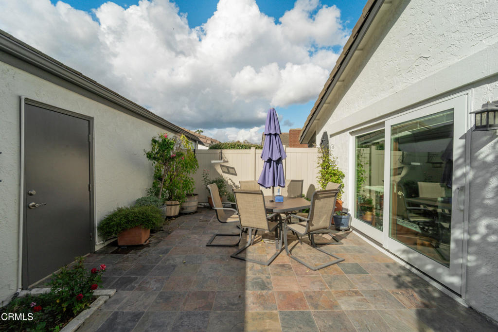 5290 Shiloh Way Ventura, CA 93003 - Photo 16 of 22 a view of a patio with table and chairs and potted plants