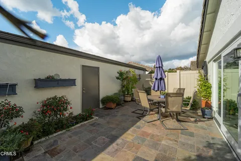 a view of a patio with table and chairs and potted plants