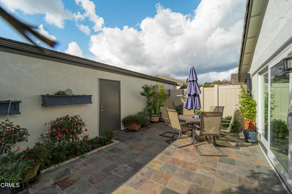 5290 Shiloh Way Ventura, CA 93003 - Photo 17 of 22 a view of a patio with table and chairs and potted plants