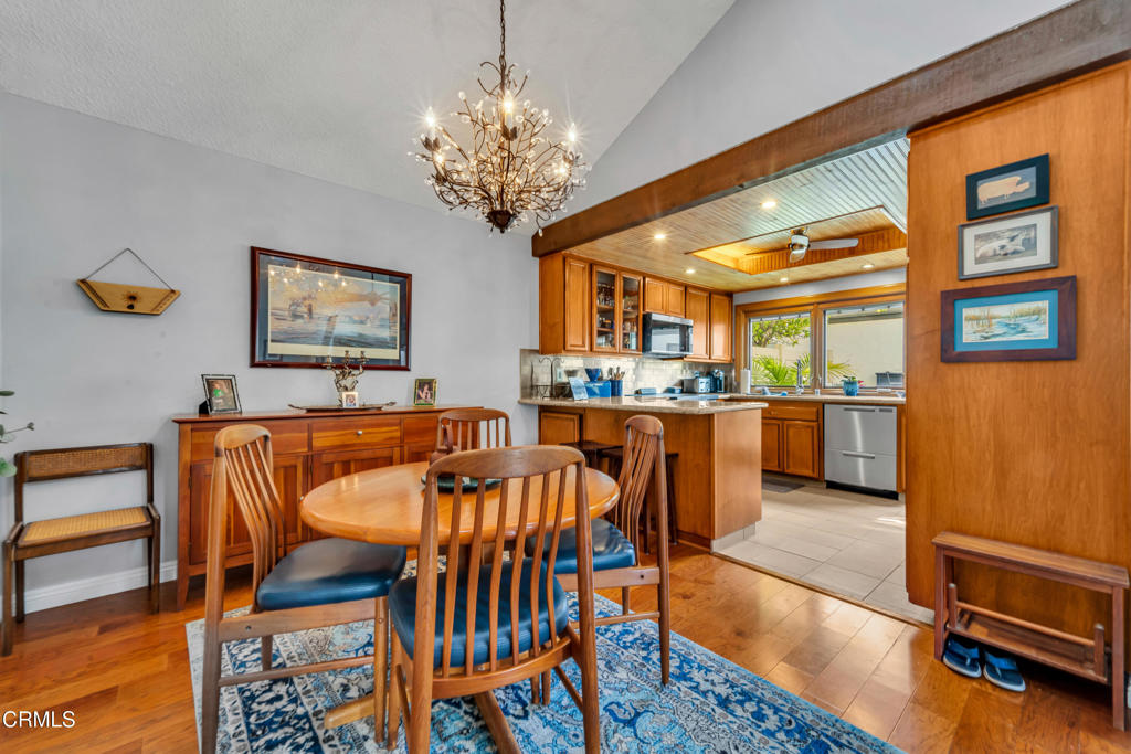 5290 Shiloh Way Ventura, CA 93003 - Photo 5 of 22 a view of a dining room with furniture a chandelier and wooden floor