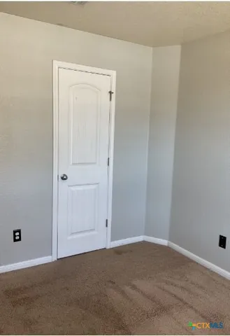a view of a livingroom with washer and dryer