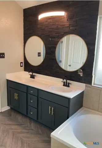 a bathroom with a sink and a mirror