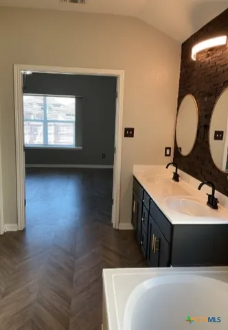 a bathroom with a shower and a sink