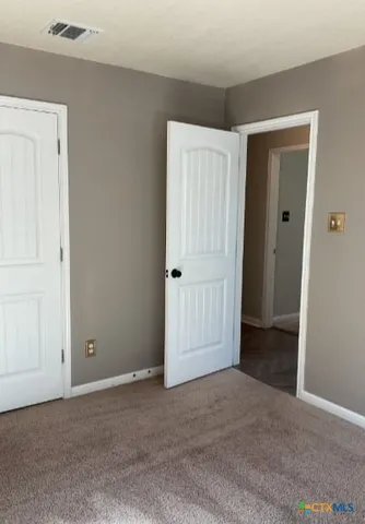 a bathroom with a double vanity sink toilet and a mirror