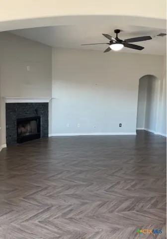 a view of an empty room with a fireplace