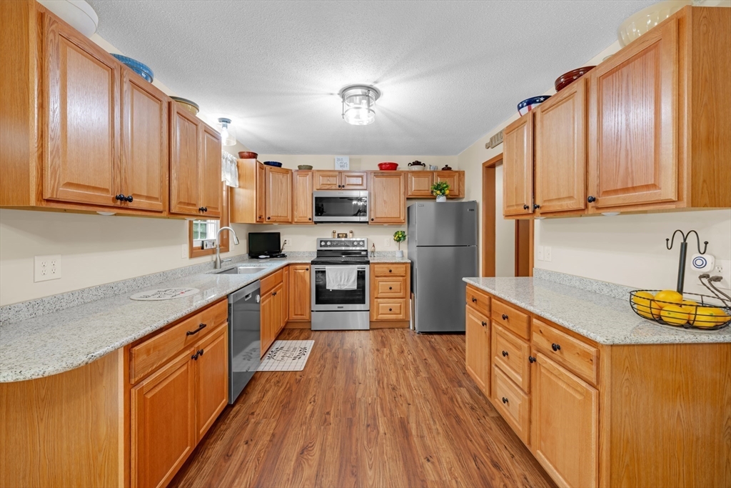 150 Osborne Road Ware, MA 01082 - Photo 16 of 38 a kitchen with stainless steel appliances granite countertop wooden cabinets a refrigerator a sink and a stove