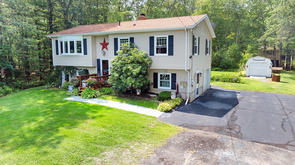 150 Osborne Road Ware, MA 01082 - Photo 2 of 38 a front view of a house with a yard and garage