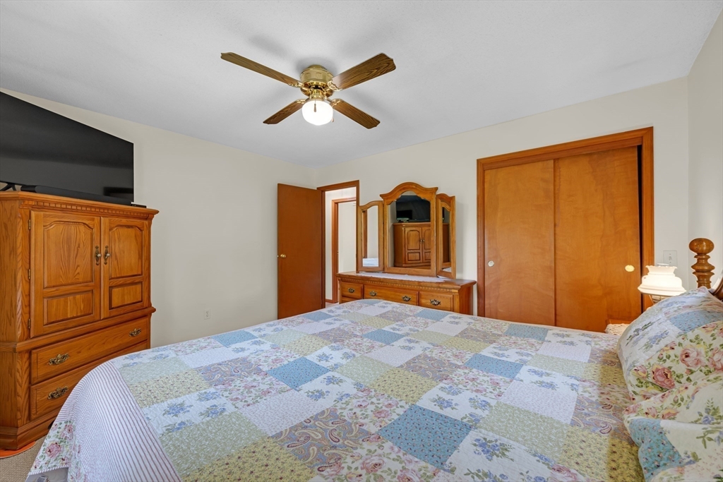 150 Osborne Road Ware, MA 01082 - Photo 22 of 38 a bedroom with a bed and a chandelier