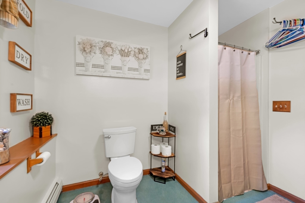 150 Osborne Road Ware, MA 01082 - Photo 32 of 38 a white toilet sitting next to a bathroom sink
