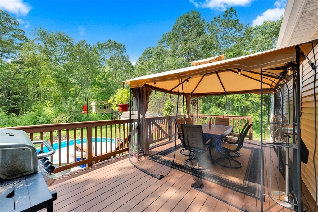 150 Osborne Road Ware, MA 01082 - Photo 10 of 38 a view of balcony with furniture and umbrella