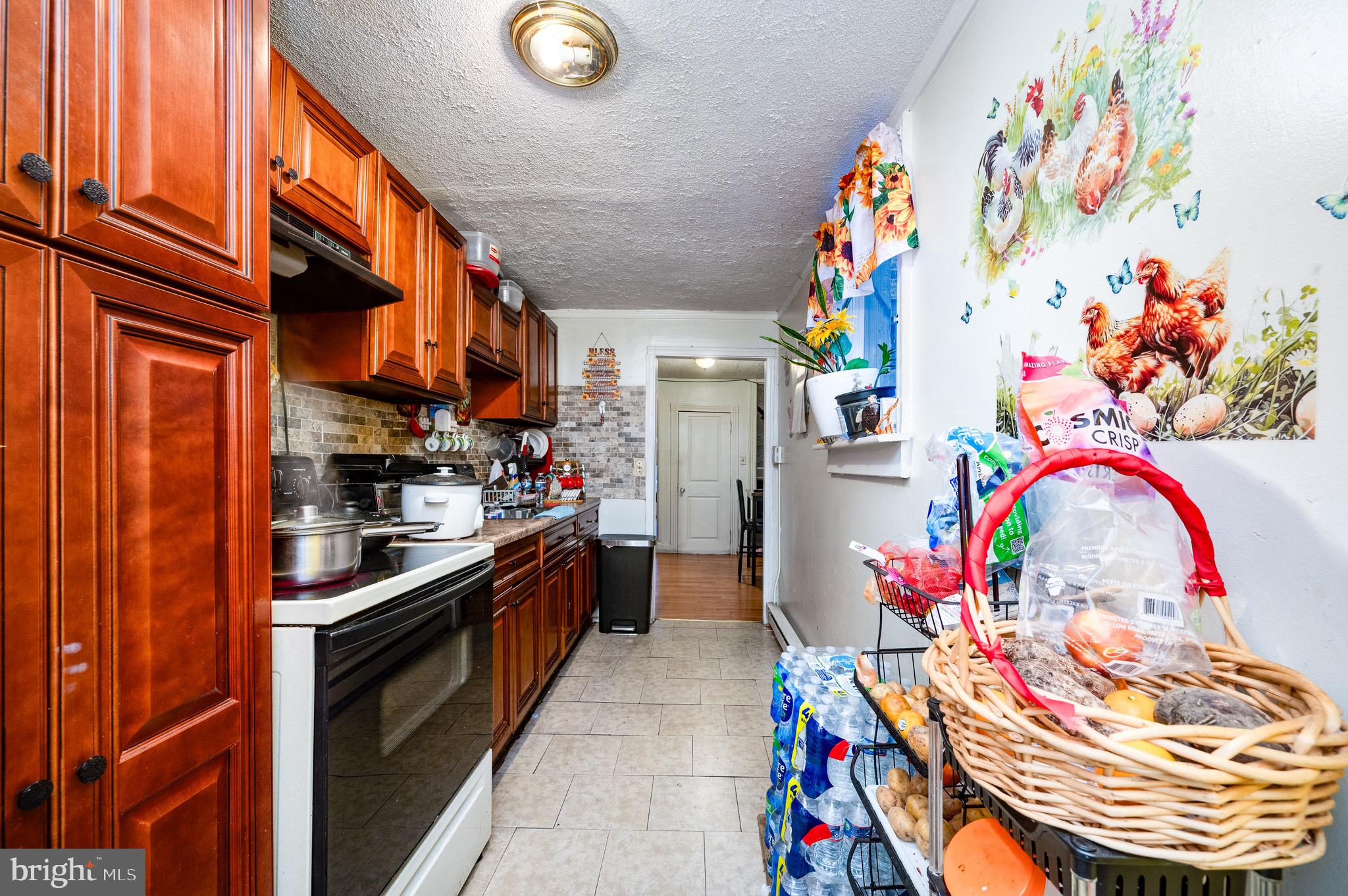 419 North 2nd Street Reading, PA 19601 - Photo 19 of 34 a kitchen with stainless steel appliances granite countertop a dining table and a stove