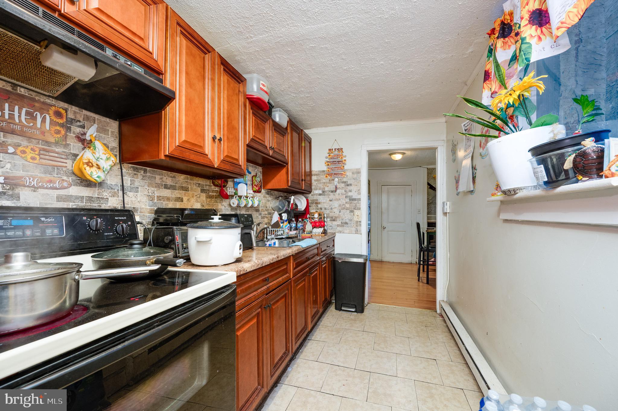 419 North 2nd Street Reading, PA 19601 - Photo 20 of 34 a kitchen with stainless steel appliances granite countertop a lot of cabinets