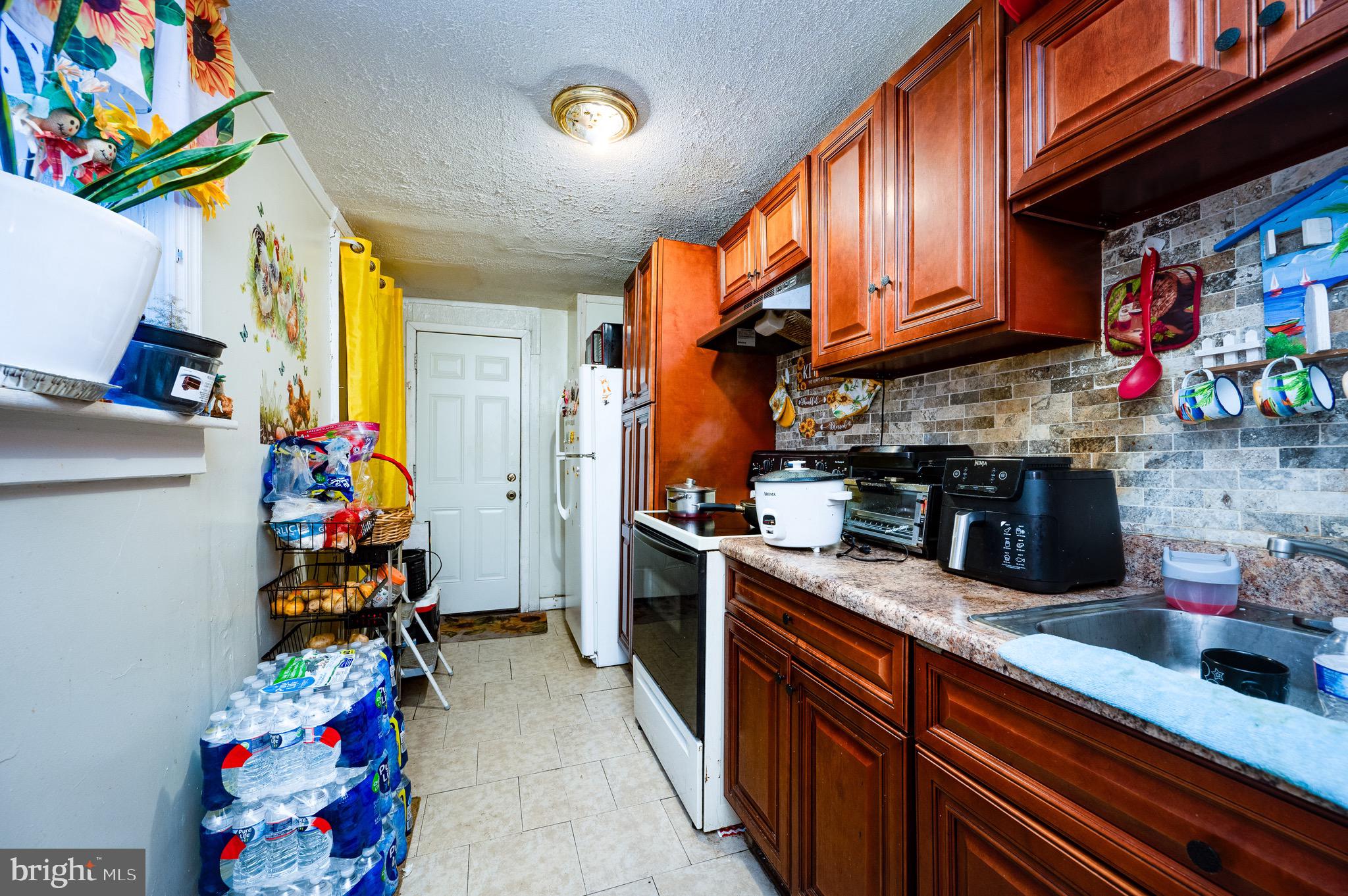 419 North 2nd Street Reading, PA 19601 - Photo 22 of 34 a kitchen with lots of clutter and stainless steel appliances