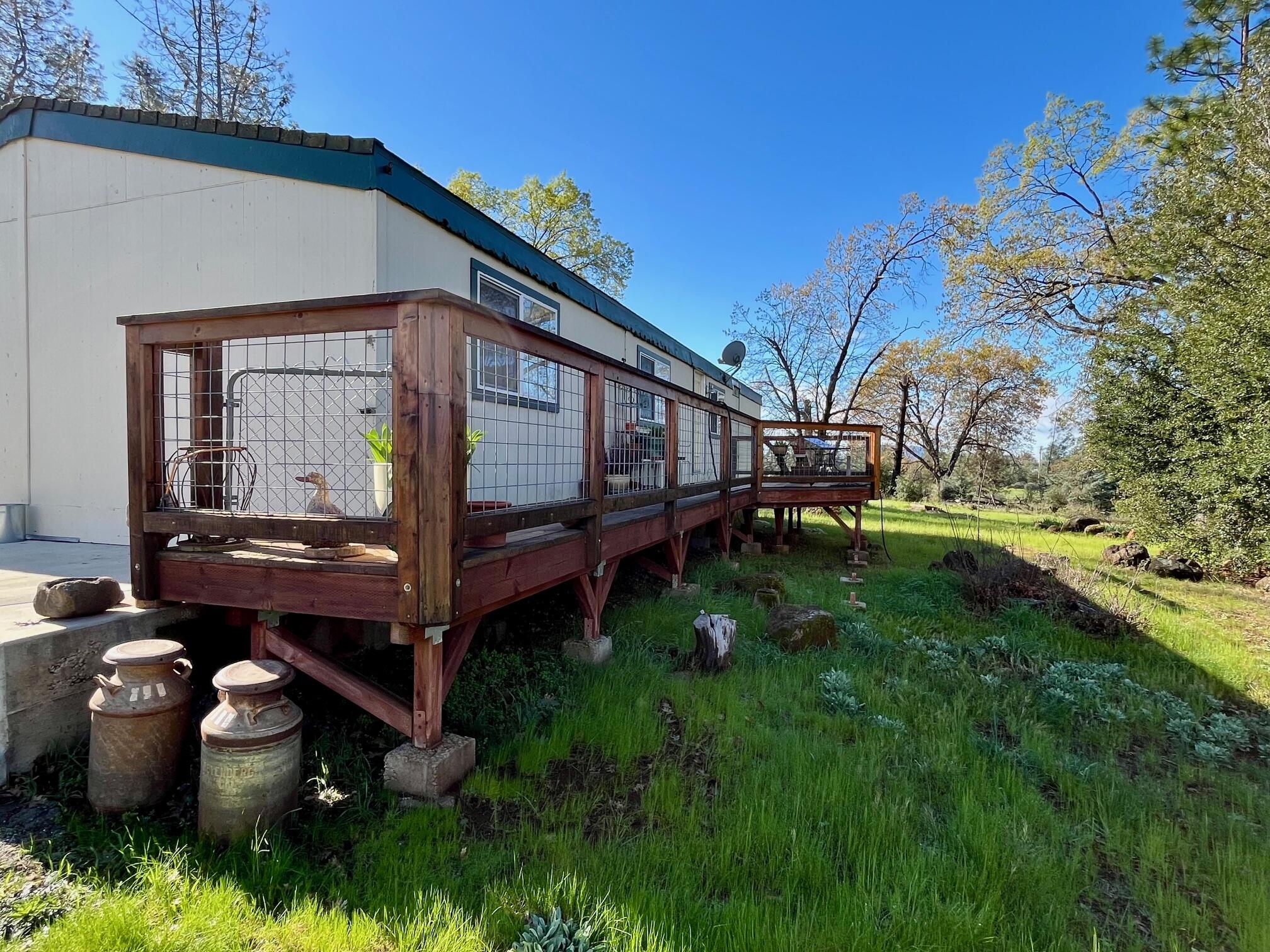 21875 Manton School Road Manton, CA 96059 - Photo 6 of 18 a backyard of a house with wooden fence and large trees