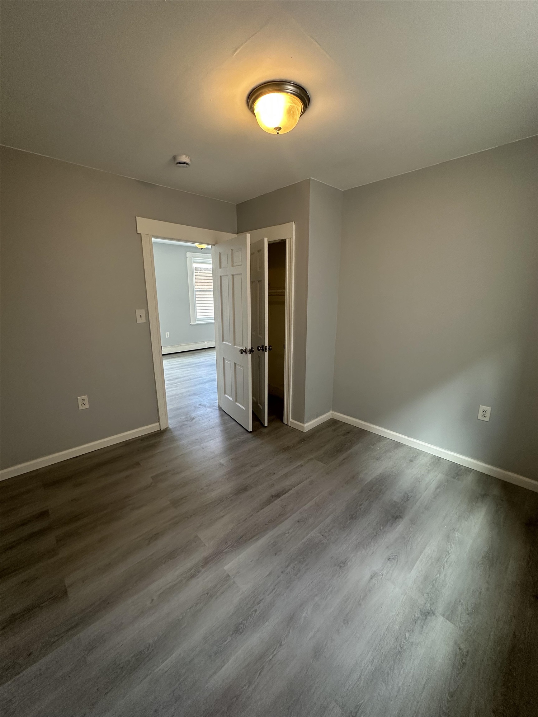 35 Norfolk Street, Unit 3 Newark, NJ 07103 - Photo 11 of 24 an empty room with wooden floor and windows