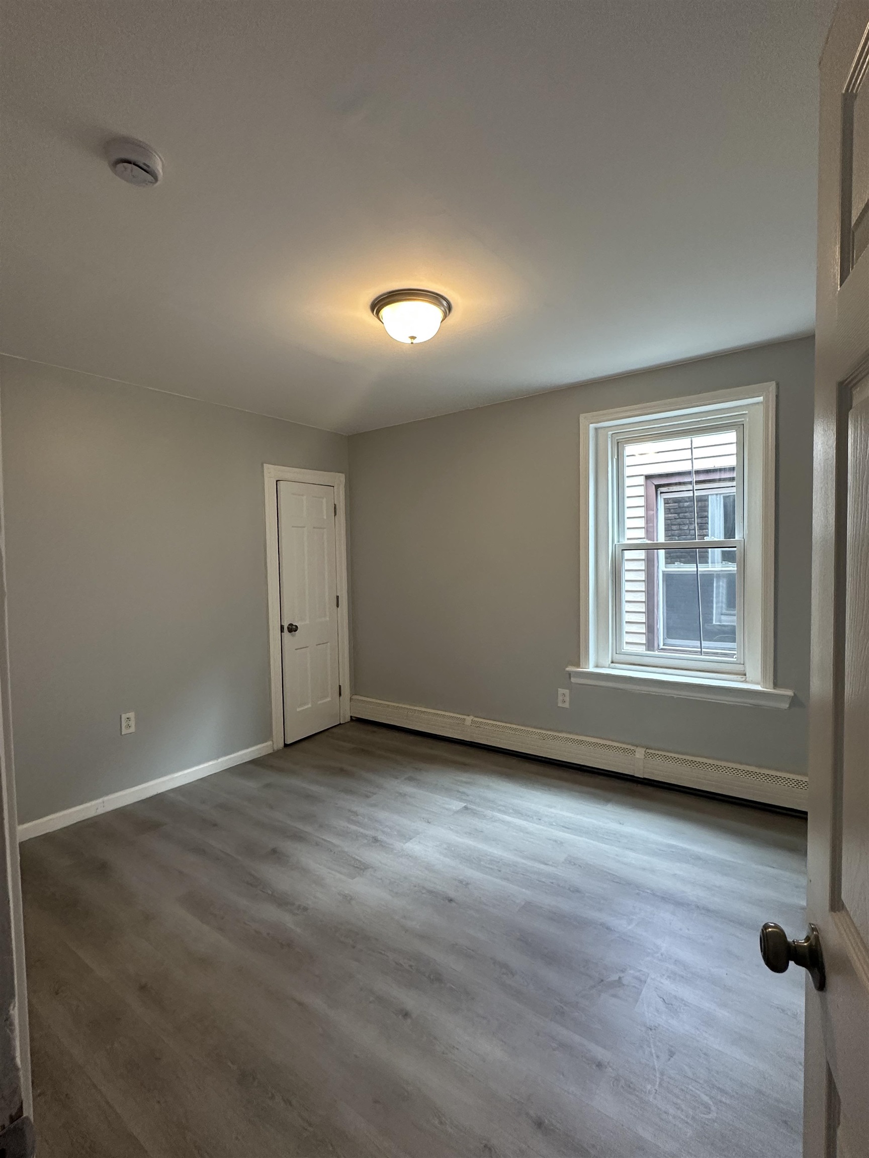 35 Norfolk Street, Unit 3 Newark, NJ 07103 - Photo 15 of 24 wooden floor in an empty room with a window