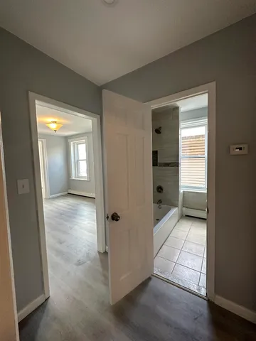 a view of a hallway with wooden shelves