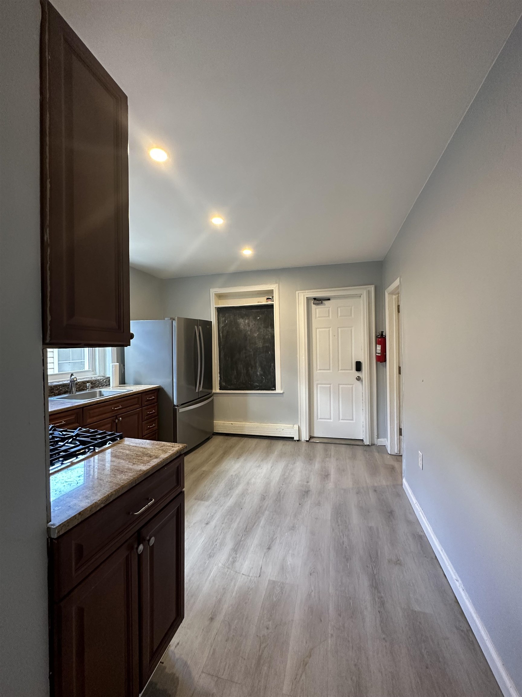 35 Norfolk Street, Unit 3 Newark, NJ 07103 - Photo 20 of 24 a kitchen with granite countertop a sink and a stove top oven