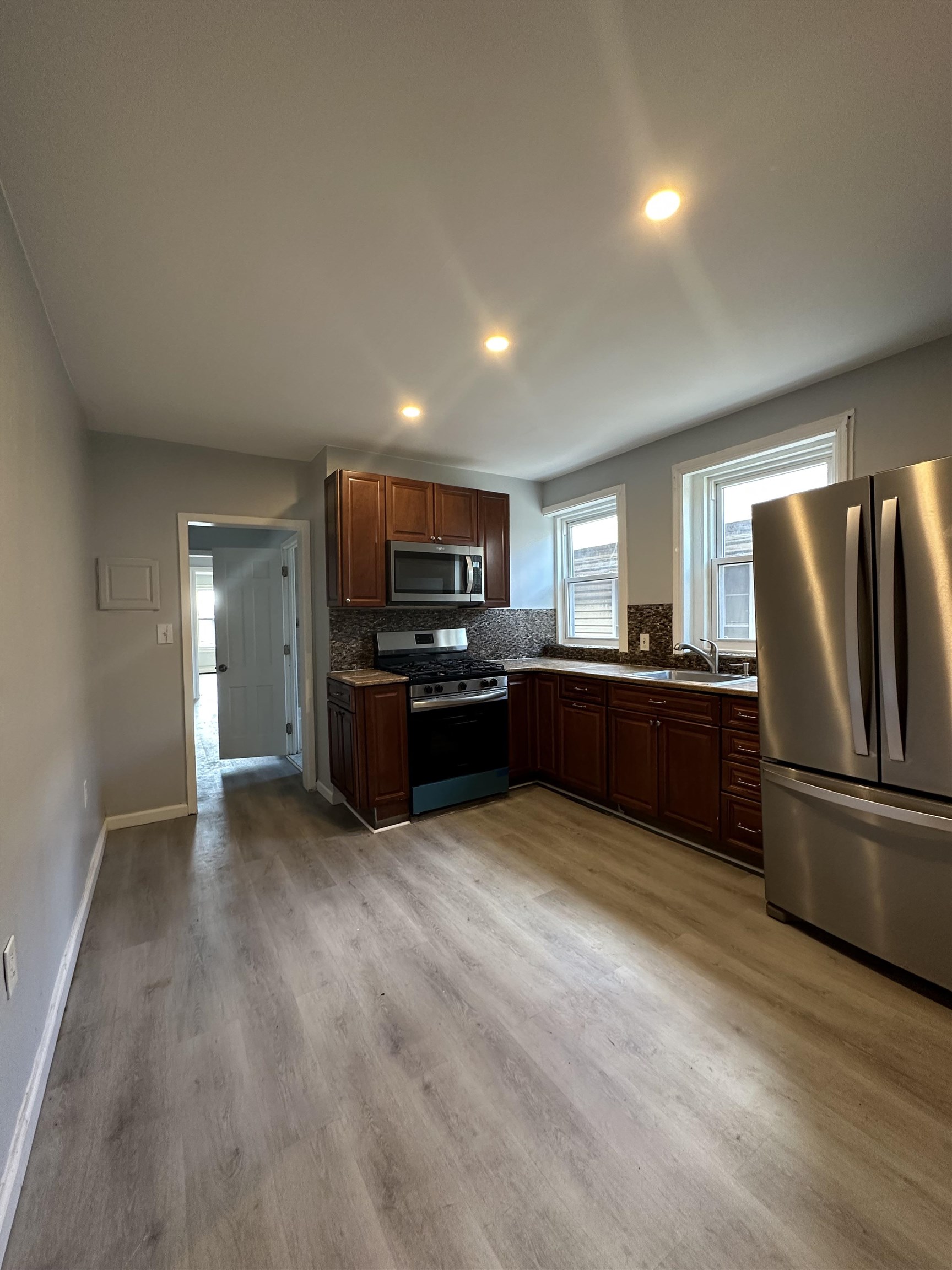 35 Norfolk Street, Unit 3 Newark, NJ 07103 - Photo 21 of 24 a kitchen with stainless steel appliances a refrigerator and a stove top oven