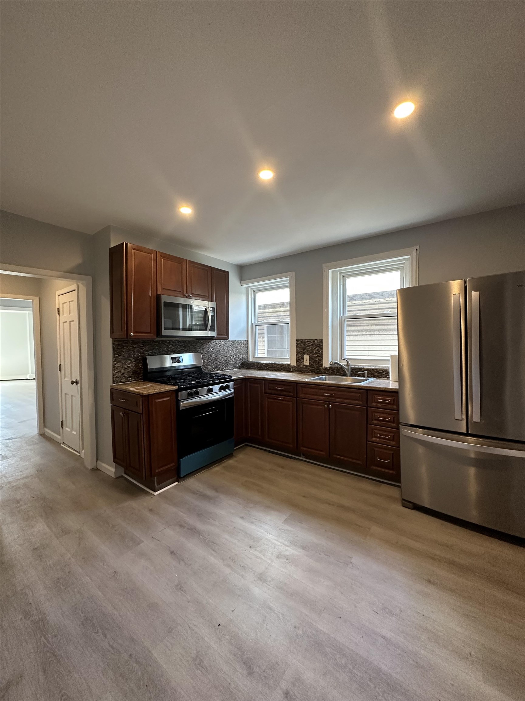 35 Norfolk Street, Unit 3 Newark, NJ 07103 - Photo 22 of 24 a kitchen with stainless steel appliances kitchen island granite countertop a refrigerator and a stove top oven