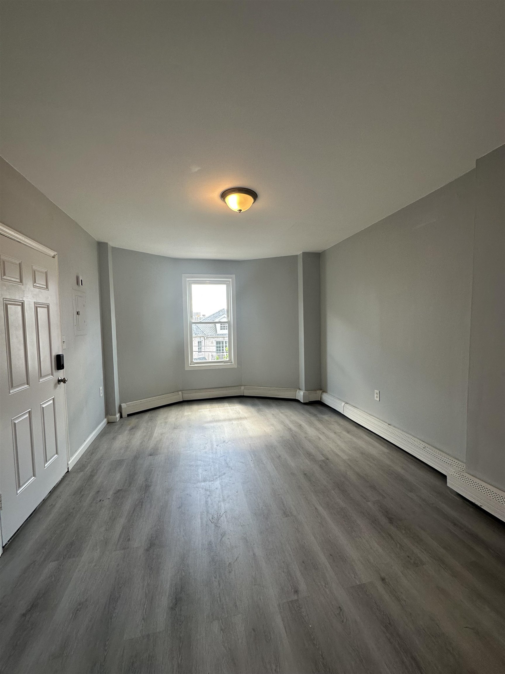 35 Norfolk Street, Unit 3 Newark, NJ 07103 - Photo 3 of 24 an empty room with wooden floor and windows