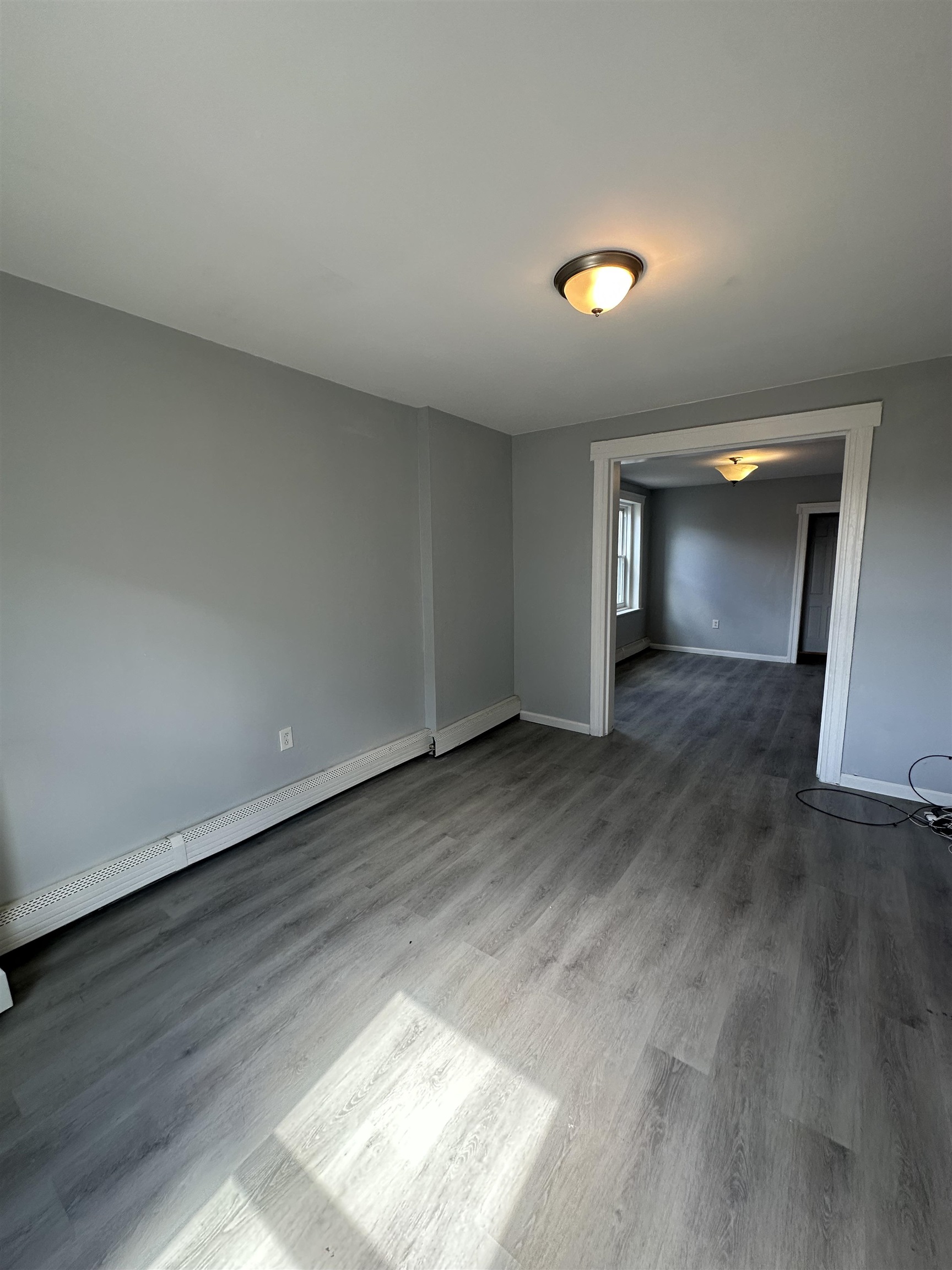 35 Norfolk Street, Unit 3 Newark, NJ 07103 - Photo 5 of 24 an empty room with wooden floor and windows