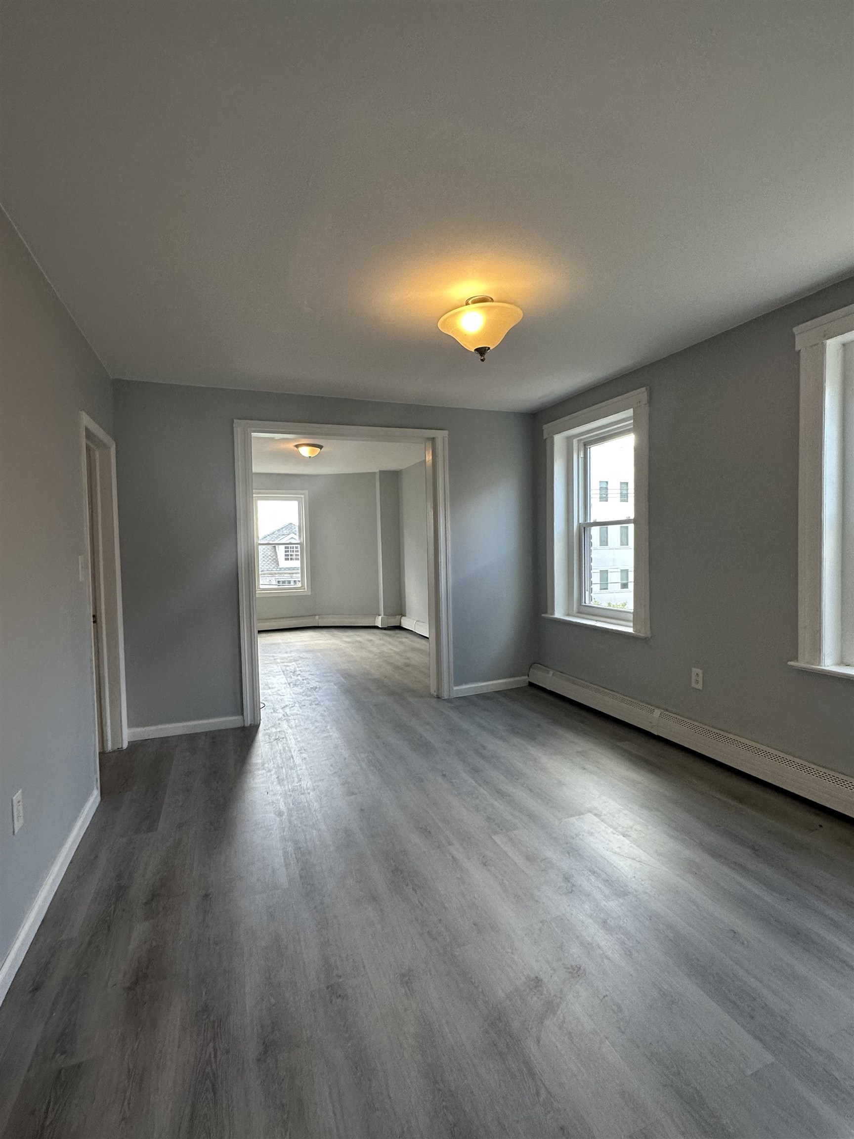 35 Norfolk Street, Unit 3 Newark, NJ 07103 - Photo 9 of 24 an empty room with wooden floor and windows