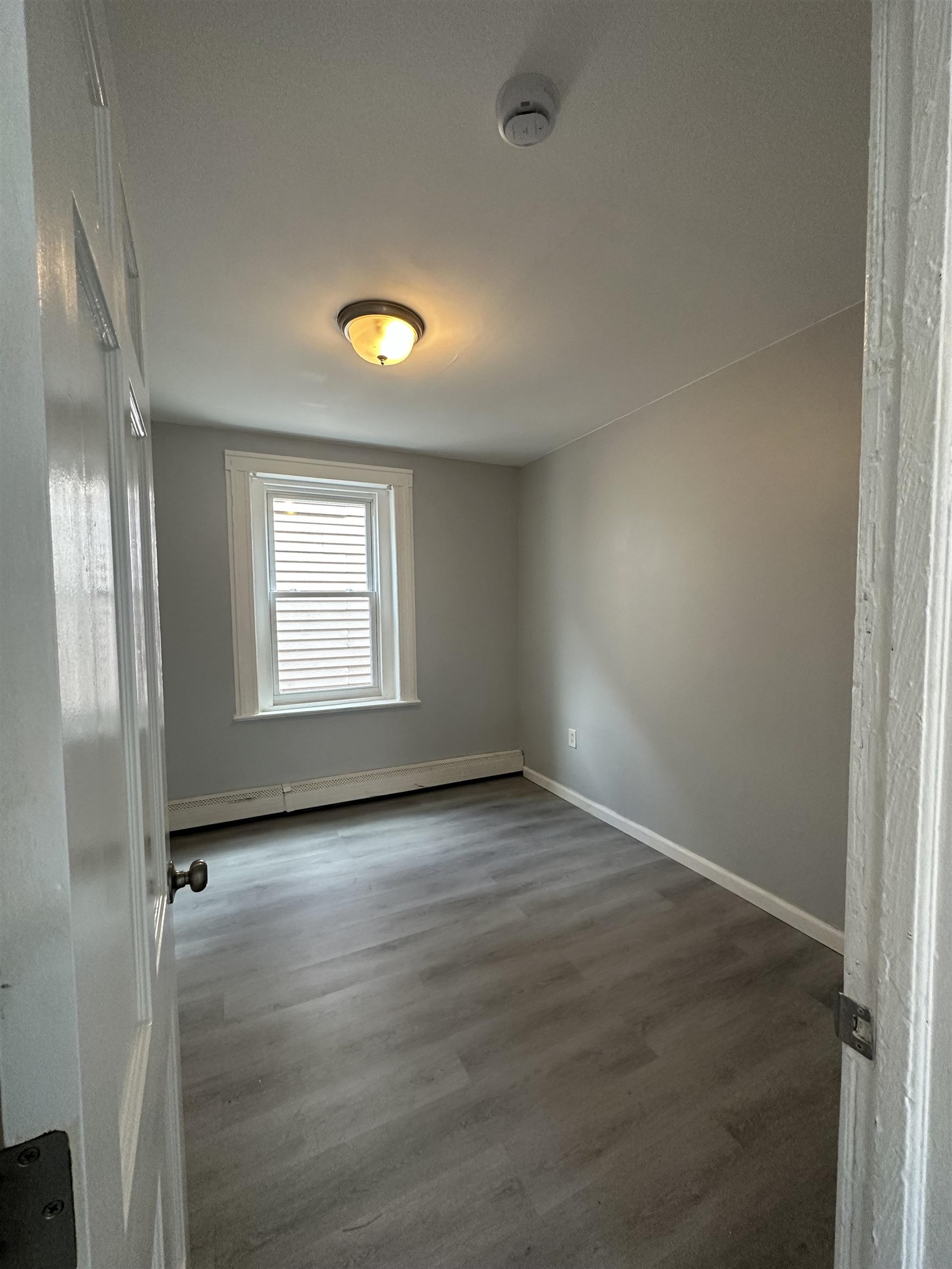 35 Norfolk Street, Unit 3 Newark, NJ 07103 - Photo 10 of 24 wooden floor in an empty room with a window