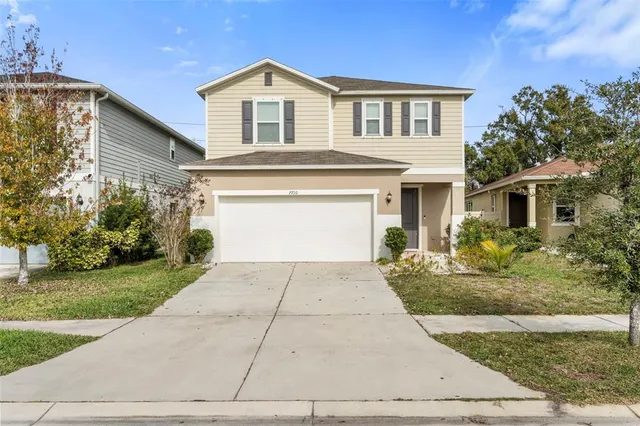 a front view of a house with a yard and garage