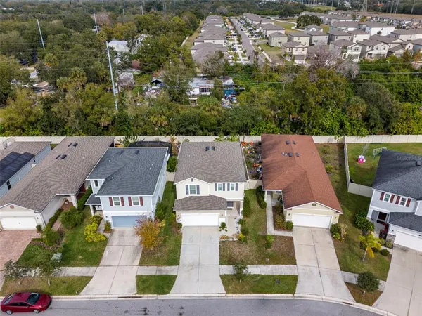 an aerial view of a house with a backyard space