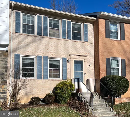 a view of a brick house with large windows