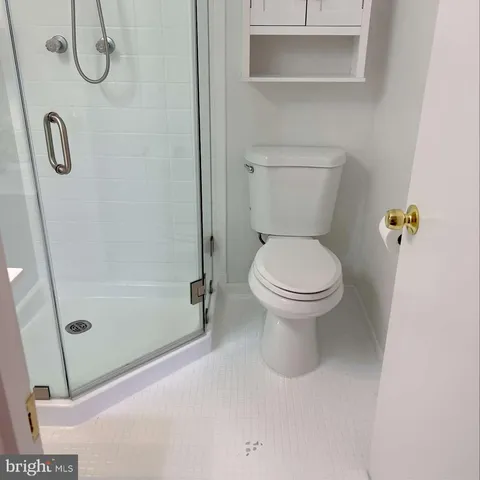 a bathroom with a toilet and a shower