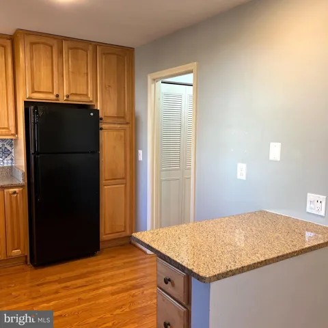 a kitchen with kitchen island a refrigerator freezer and a dishwasher