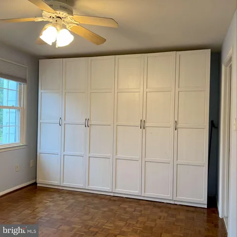 an empty room with chandelier fan