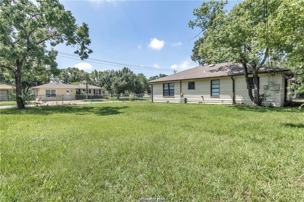 1510 Burt Street Bryan, TX 77802 - Photo 15 of 15 a view of a house with a big yard and potted plants and large trees