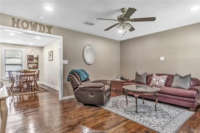a living room with furniture a rug and a chandelier