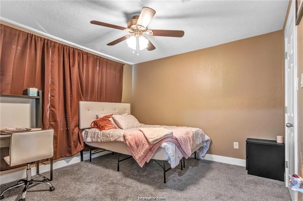 1510 Burt Street Bryan, TX 77802 - Photo 4 of 15 a bedroom with a bed and a chandelier