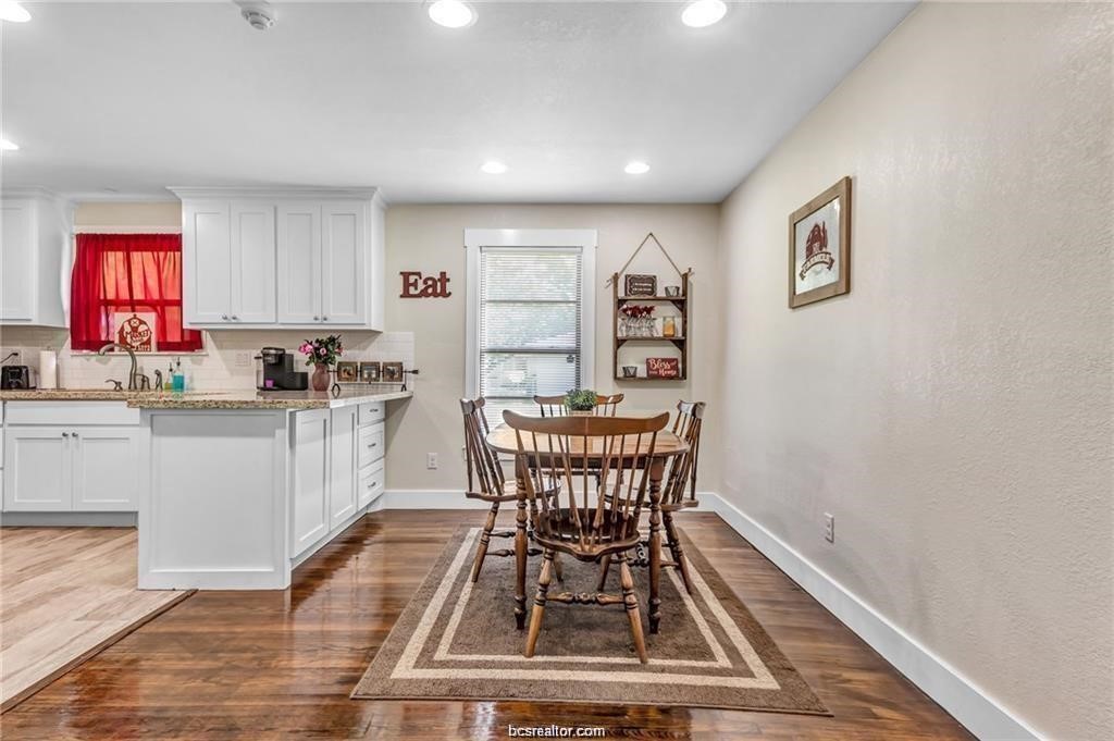 1510 Burt Street Bryan, TX 77802 - Photo 7 of 15 a kitchen with granite countertop a dining table chairs and a window