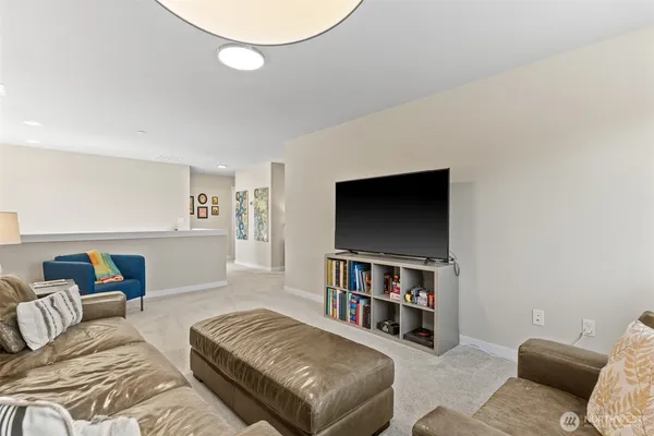 a living room with furniture and a shelf
